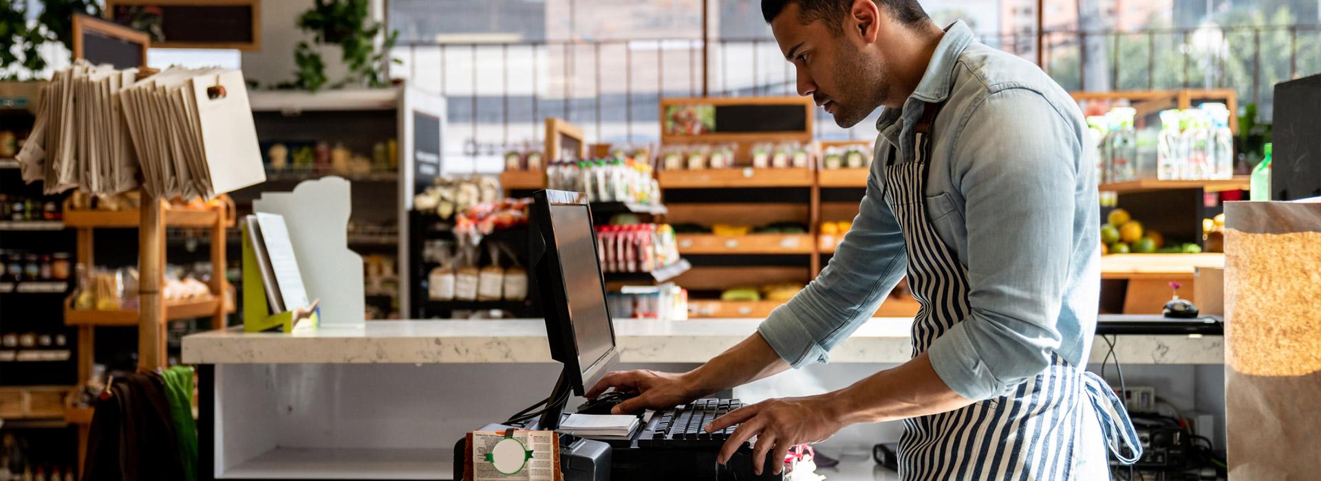 barista standing at cash register