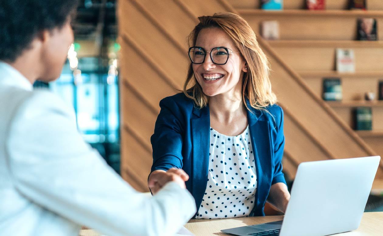woman in shop shaking hands