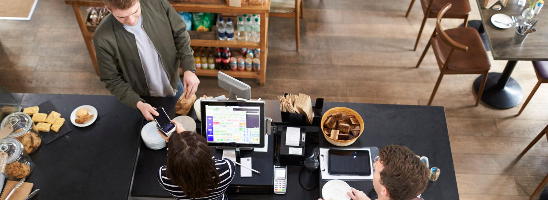 man purchasing items at coffee shop