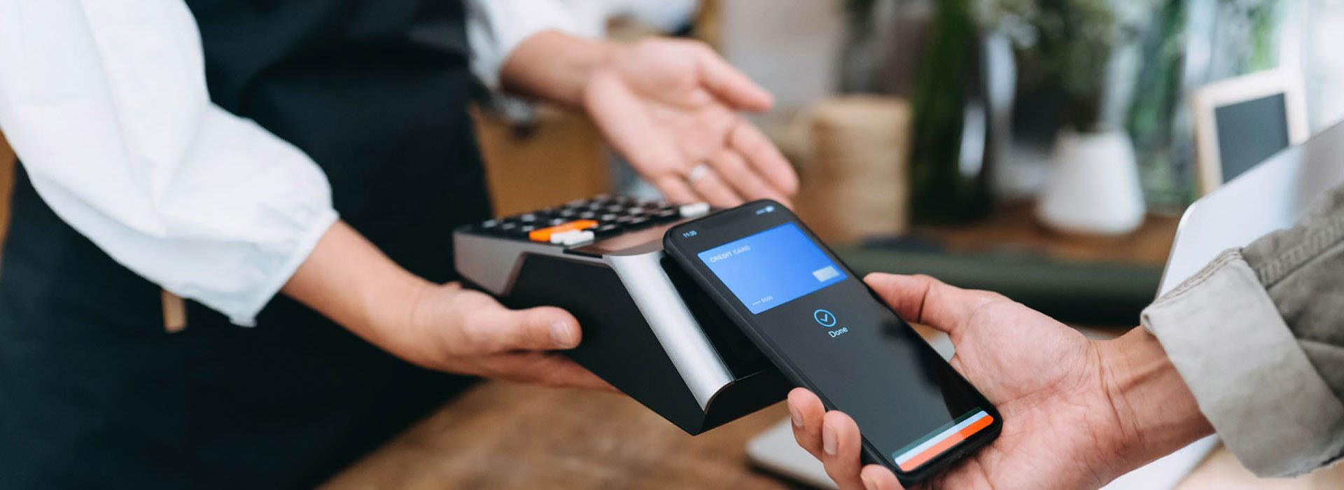 man using cellphone for tap to pay