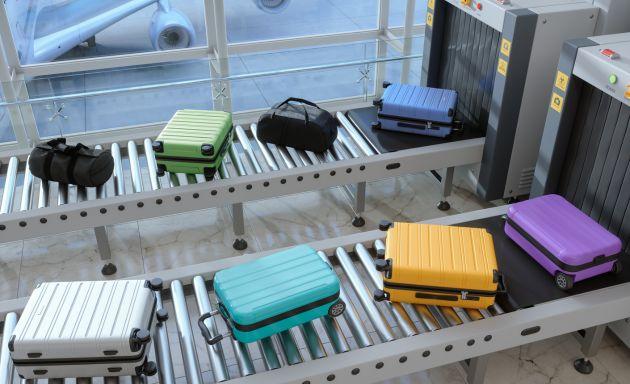 Luggage on rail to go through scanner